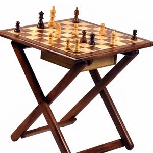 May include: A wooden folding table with a built-in chessboard top featuring light and dark squares. The table has a dark brown finish and an X-shaped base. Several light and dark wooden chess pieces are arranged across the board surface.