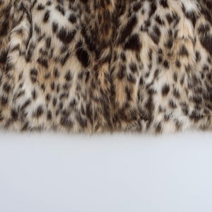Women’s polyester faux fur jacket with a leopard-inspired printed pattern, cozy plush texture, long sleeves, and a warm winter design