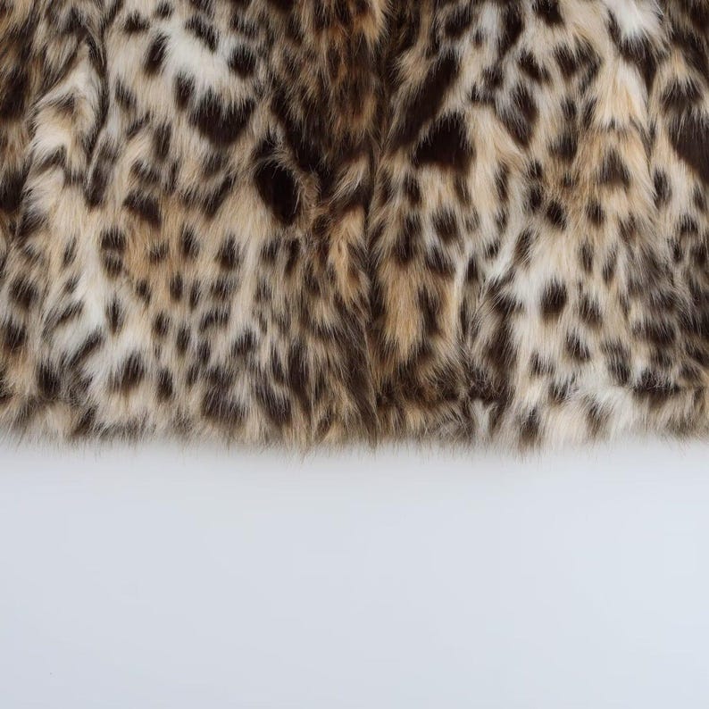 Women’s polyester faux fur jacket with a leopard-inspired printed pattern, cozy plush texture, long sleeves, and a warm winter design