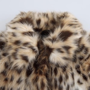 Women’s polyester faux fur jacket with a leopard-inspired printed pattern, cozy plush texture, long sleeves, and a warm winter design