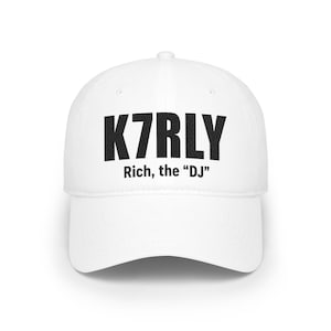 May include: A white baseball cap featuring the black text K7RLY printed in a bold sans-serif font on the front panel, with the additional black text Rich, the “DJ” printed in a smaller font size directly underneath the main lettering.