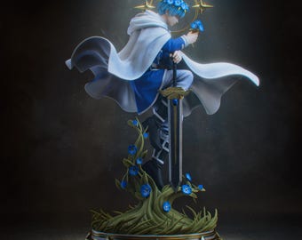 May include: A fantasy figurine of a blue-haired character wearing a white hooded cape and blue tunic, kneeling on a base of green vines with blue flowers. The character holds a small blue flower and rests a hand on a large sword with a blue gem.