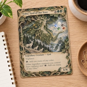 May include: A rectangular trading card titled Esika, God of the Tree, featuring a layered, three-dimensional paper art illustration of a forest deity with leafy hair, deer, and a castle. The card displays game text, mana symbols, and a 1/4 power/toughness.