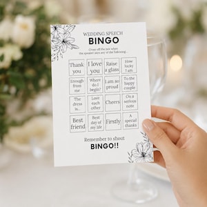 May include: A white rectangular wedding speech bingo card with black text and floral illustrations. The grid contains phrases like Thank you, I love you, Raise a glass, and How lucky I am. The bottom text reads Remember to shout BINGO!!