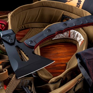 May include: A black tactical hatchet featuring a matte finish, a curved blade with a cutout design, and a handle with red accent layers secured by three visible screws. The tool has a sharp edge and a reinforced head construction for utility use.