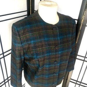 May include: A blue, brown, and green plaid blazer with a button closure.