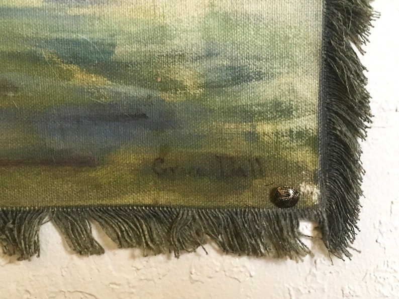 May include: An abstract painting in shades of green and blue with a fringed edge and a small metal tag. The painting is signed "G.C. Hall" in the bottom right corner.