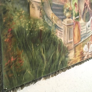 May include: A tapestry featuring a garden scene with a stone building, a pond, and two swans. The tapestry is predominantly green, brown, and white and has a fringed border.