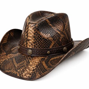 May include: A brown and black cowboy hat featuring a textured snakeskin pattern across the crown and brim. The hat includes a dark brown braided leather band accented with circular metallic studs and decorative silver-toned concho ornaments.