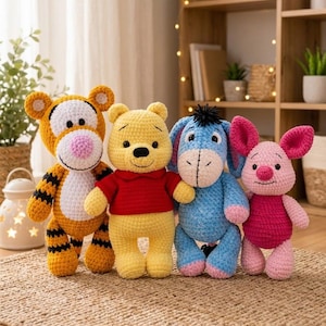 May include: Four crocheted plush toys standing in a row. From left to right: an orange and black striped tiger, a yellow bear wearing a red shirt, a light blue donkey with a black tuft of hair, and a small pink pig with large ears.
