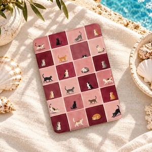 May include: A rectangular tablet case featuring a grid pattern of alternating dark red and light pink squares. Each square contains a small, detailed illustration of a cat in various poses, including sitting, stretching, and sleeping.
