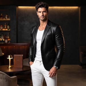 Male model wearing the black leather blazer in a stylish upscale evening setting.