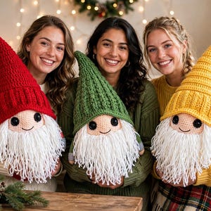 May include: Three handmade crochet gnome plush toys featuring tall pointed hats in solid red, green, and yellow. Each gnome has a round beige face, black button eyes, a stitched smile, and a long, thick white yarn beard.