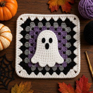 May include: A square crochet granny square featuring a white ghost applique in the center. The square is worked in concentric rounds of white, black, grey, and purple yarn. The ghost has two black oval eyes and a black oval mouth.