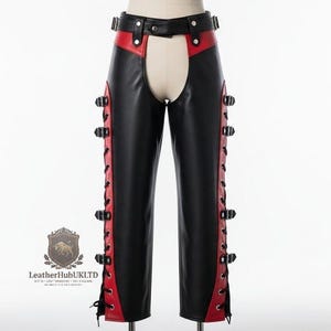 May include: Black and red leather chaps featuring a waist belt with a buckle, side lacing with metal eyelets, and multiple adjustable side straps with buckles. The logo for LeatherHubUKLTD is visible in the lower left corner of the image.