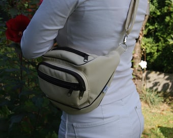 Marsupio/zaino in ecopelle con ricamo di struzzo. Color ecru. Autentico. Pezzo unico. 4 tasche con cerniera. Tracolla lunga.