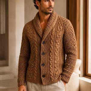 May include: A brown knit cardigan featuring a shawl collar, long sleeves, and four dark buttons down the front. The garment displays a textured pattern with vertical cable knit details and a basketweave stitch design on the front and sleeves.