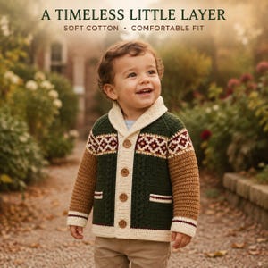 May include: A long-sleeve button-up cardigan featuring a dark green body, brown sleeves, and a cream-colored shawl collar. The garment includes a geometric pattern across the chest, two front pockets, and the text A TIMELESS LITTLE LAYER SOFT COTTON • COMFORTABLE FIT.