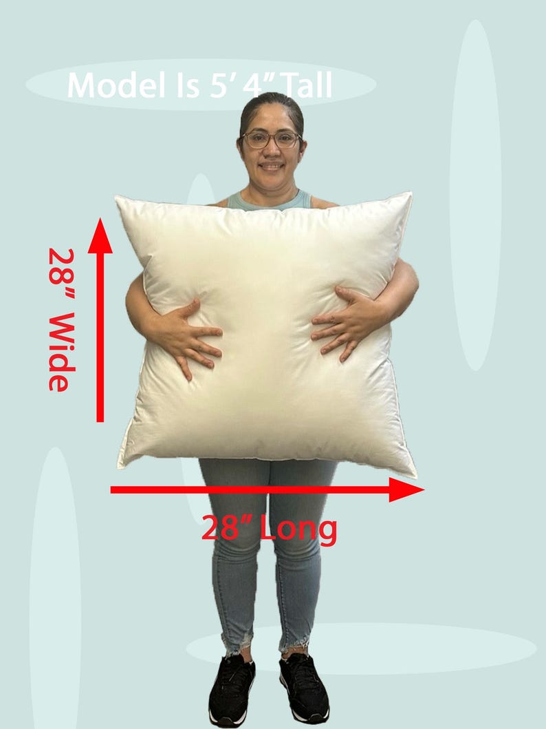 Lady holding a small 28x28 pillow insert to demonstrate the size of the pillow form and how do I correctly measure my sham.  What size insert does an 26x26 sham need?  28 by 28 pillow inserts best fits a 26 by 26 decorative pillow sham.  What size pillow does my decorative sham need.  What size pillow insert does my 27 by 27 pillow cover need?