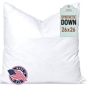 May include: A white pillow with the text "SYNTHETIC DOWN 26x26" on a tag. The pillow is made in the USA and has a round sticker with the American flag. The pillow is square and appears to be filled with a soft material.