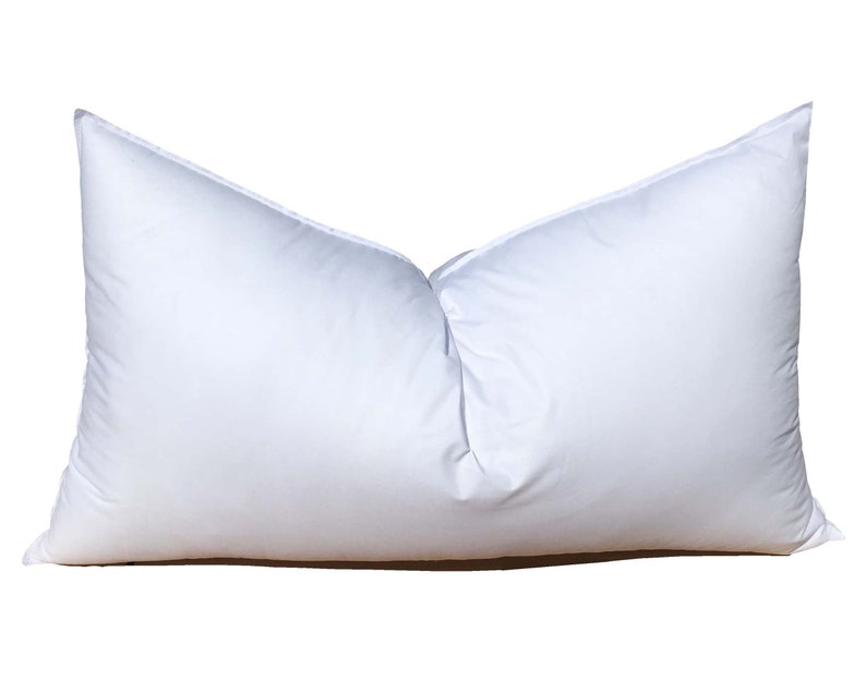 May include: A white rectangular pillow with a smooth, soft surface. The pillow is filled with down feathers and is designed for comfortable sleeping.