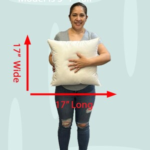 Lady holding a small 17x17 pillow insert to demonstrate the size of the pillow form and how do I correctly measure my sham.  What size insert does an 16x16 sham need?  17 by 17 pillow inserts best fits a 16 by 16 decorative pillow sham.  What size pillow does my decorative sham need.  What size pillow insert does my 17 by 17 pillow cover need?