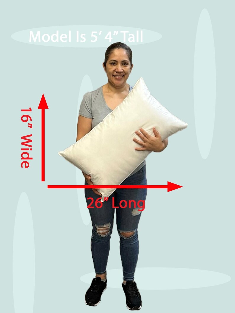Lady holding an 16x26 pillow insert to demonstrate the size of the pillow form and how do I correctly measure my sham.  What size insert does an 15x25 lumbar sham need?  16 by 26 pillow inserts best fits a 16 by 24 decorative pillow sham.  What size pillow does my decorative sham need.  What size pillow insert does my 15 by 26 travel pillow cover need?