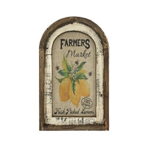 May include: A rustic wooden framed sign with a whitewashed finish. The sign features a burlap background with a vintage illustration of lemons and bees. The text on the sign reads "Farmers Market", "100% Organic", and "Fresh Picked Lemons".