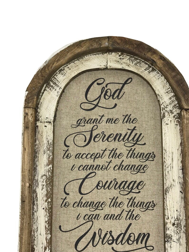 May include: A rustic wooden framed sign with a whitewashed finish and a linen canvas insert. The sign features a black text quote: "God grant me the Serenity to accept the things I cannot change, Courage to change the things I can, and the Wisdom"