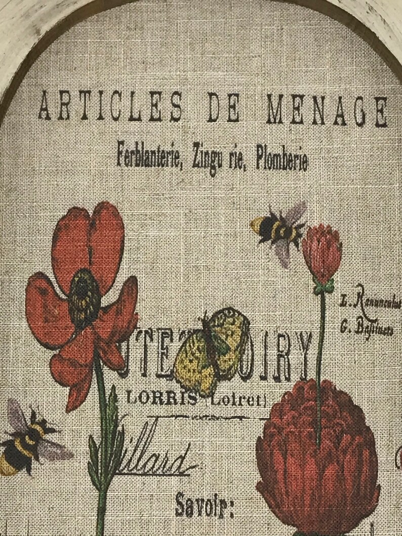 May include: A vintage-style print with the text "ARTICLES DE MENAGE Ferblanterie, Zingu rie, Plomberie" and a floral design featuring red poppies, a yellow butterfly, and black and yellow bees.