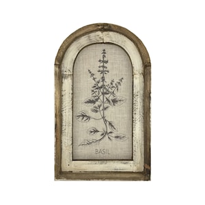 May include: A framed print of a basil plant with the word "BASIL" printed below the image. The frame is a rustic wood with a whitewashed finish.
