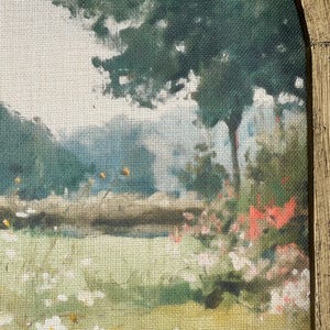 May include: A landscape painting featuring a field of wildflowers and a large tree. The artwork uses a palette of greens, yellows, and whites, with a hint of red flowers. The painting is framed in a gold-colored, arched wooden frame.