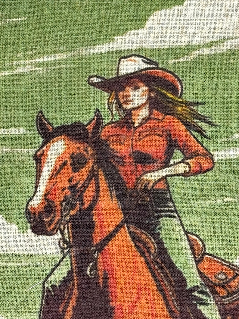 May include: A woman wearing a red shirt and a white cowboy hat rides a brown horse. The horse is facing the left side of the image. The background is a green and white textured fabric.