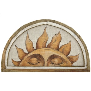 May include: A wooden half-circle wall decor with a white linen background and a hand-painted sun with closed eyes. The sun is in shades of brown and yellow.