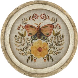 May include: A round wooden wall decor with a beige linen background featuring a colorful butterfly with floral accents.