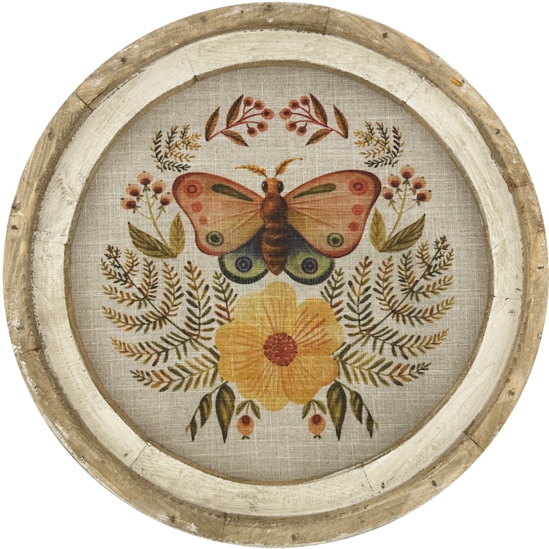 May include: A round wooden wall decor with a beige linen background featuring a colorful butterfly with floral accents.