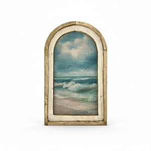 a painting of a beach scene with waves crashing on the shore, framed in an arched wooden frame.