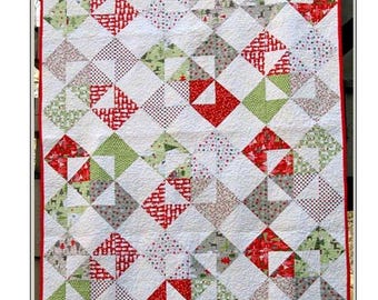 May include: A quilt pattern featuring a patchwork design with red, green, and white squares and triangles. The quilt is titled "Christmas Cards" and is by Four Robbins Designs.