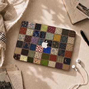 Peut inclure: Un autocollant pour ordinateur portable rectangulaire présentant un motif patchwork composé de petits carrés aux imprimés variés dans des tons de bleu, vert, rouge, jaune et marron, avec une découpe logo Apple blanc et une lune.