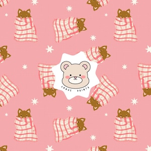 May include: A repeating pattern on a pink background featuring brown bears wrapped in white and pink striped blankets, interspersed with white stars. A central white star-shaped label displays a bear face and the text JAQUE PRINTS.