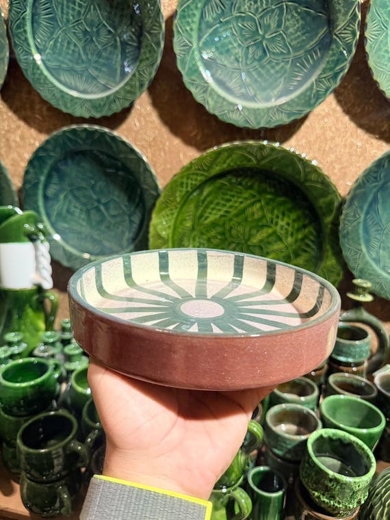 Hand-thrown Moroccan ceramic bowl with bold artisan stripes — the kind of statement piece that makes a dinner table look intentionally curated.