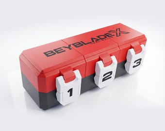 May include: A rectangular storage case with a red lid and black base, featuring the text BEYBLADE X on top. The front has three white latches labeled with the black numbers 1, 2, and 3, designed to secure the compartments of the plastic container.