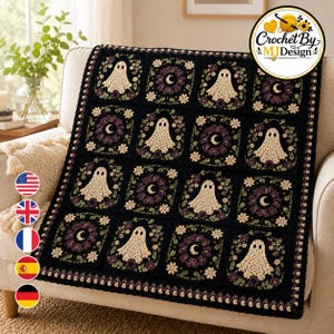 May include: A black crochet blanket featuring alternating square motifs. One set of squares displays a cream-colored ghost, while the other set features a crescent moon surrounded by purple and green floral accents. The blanket has a decorative border.