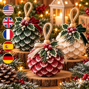 May include: Three crocheted ornaments shaped like pinecones in red, white, and dark green. Each ornament features a jute twine loop, a wooden bead, crocheted holly leaves, red berries, and a fabric ribbon bow attached to the top.