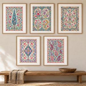 May include: A set of five rectangular wall art prints in light wood frames, each featuring intricate, colorful floral and paisley patterns in shades of pink, blue, green, and yellow, arranged in a gallery display on a neutral-colored wall.