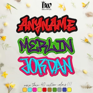 May include: Three embroidered name patches in a graffiti-style font. The top patch is red with a black border reading ANYNAME. The middle patch is purple with a green border reading MERLIN. The bottom patch is blue with a pink border reading JORDAN.