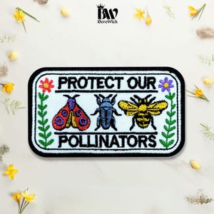 May include: A rectangular embroidered patch with a light blue background and black border. It features the text PROTECT OUR POLLINATORS in black, flanked by green floral stems. The design includes a red moth, a blue beetle, and a yellow bee.