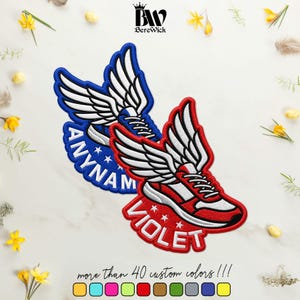 May include: Two embroidered patches featuring sneakers with large white wings. One patch is blue with the text ANYNAM, the other is red with the text VIOLET. Both include white stars and detailed stitching, showcasing a winged footwear design.