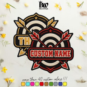 May include: Two circular embroidered patches featuring a target design with crossed arrows. The front patch has a red border and red text reading CUSTOM NAME. The back patch has a gold border and gold text. Both include a small star icon.