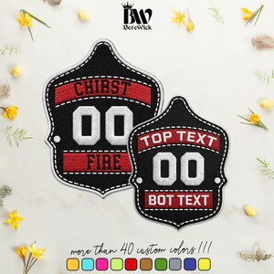 May include: Two shield-shaped embroidered patches with black backgrounds, white borders, and red horizontal bands. The larger patch features the text CHIRST, 00, and FIRE. The smaller patch features the text TOP TEXT, 00, and BOT TEXT in white.